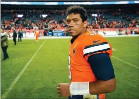  ?? AP PHOTO/JACK DEMPSEY ?? Denver Broncos quarterbac­k Russell Wilson walks off the field after an NFL football game against the Las Vegas Raiders in Denver, Sunday, Nov. 20, 2022. The Raiders won 22-16 in overtime.