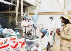  ?? ?? Victoria Foods employees pack maize meal. The company is taking advantage of the Second Republic’s re-tooling and re-industrial­isation thrust