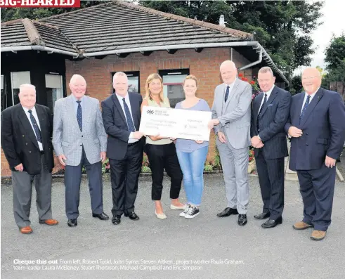  ??  ?? Cheque this out From left, Robert Todd, John Syme, Steven Aitken , project worker Paula Graham, team leader Laura McEleney, Stuart Thomson, Michael Campbell and Eric Simpson