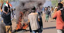  ?? | Reuters ?? A FIRE burns as protesters march during a rally last week against military rule following last month’s coup in Khartoum, Sudan. Hundreds of protesters have been injured since the coup, mainly from live gunshot and tear gas canisters, and at least 63 have died.