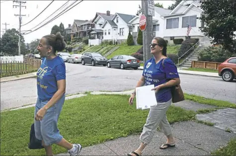  ?? Darrell Sapp/Post-Gazette ?? Brenda Marks and Christy Baraff with the Pittsburgh Federation of Teachers walk toward a home in the neighborho­od of Brookline earlier this month.