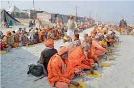  ?? — PTI ?? Sadhus and devotees at a bhandara during Magh Mela festival in Allahabad on Thursday.