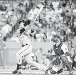  ?? Mark J. Terrill Associated Press ?? A GRAND SLAM by Buster Posey gives the Giants a 4-2 lead in the third inning. Dodgers catcher Yasmani Grandal watches it go.