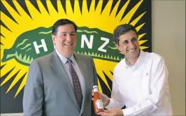  ?? Post-Gazette ?? Pittsburgh Mayor Bill Peduto, left, and H.J. Heinz Co. CEO Bernardo Hees, shown in 2014, before Heinz and Kraft merged.