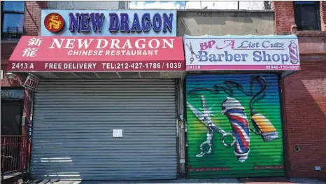  ?? BRYAN R SMITH / REUTERS ?? A Chinese restaurant and barber shop in Harlem are closed, as retail sales suffer record drop during the COVID-19 outbreak in New York on April 15.