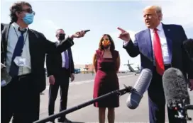  ?? AP PHOTO/ALEX BRANDON ?? President Donald Trump talks to reporters at Phoenix Sky Harbor Internatio­nal Airport on Monday in Phoenix. Second from right is Sen. Martha McSally, R-Ariz.