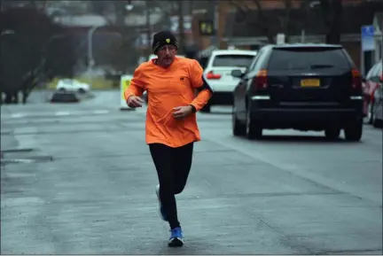  ?? TANIA BARRICKLO — DAILY FREEMAN ?? Jim Juliano of Kingston, N.Y., runs up North Front Street in Uptown Kingston Thursday morning, March 19, 2020, as part of his daily run. Juliano is a member of the Shawangunk Runners and a ShopRite employee who works at night stocking food.