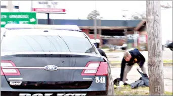  ?? (Caitlan Butler/News-Times) ?? An El Dorado police officer transfers items from a grey sedan that was reported stolen into an El Dorado Police vehicle late Wednesday morning.