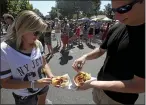  ?? EMILY BERTOLINO — ENTERPRISE-RECORD FILE ?? Elissi Bestreich and Andrew Wells are about to dive into a serving of Palooka Nacho Pie from the Wander food truck during the annual Taste of Chico in downtown Chico on Sept. 14, 2014.