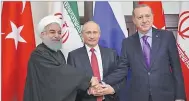  ??  ?? AA Iranian President Hassan Rouhani (L), his Russian counterpar­t, Vladimir Putin (C) and Turkish President Recep Tayyip Erdogan shake hands during the trilateral summit in Sochi, Russia, on Nov. 23, 2017.