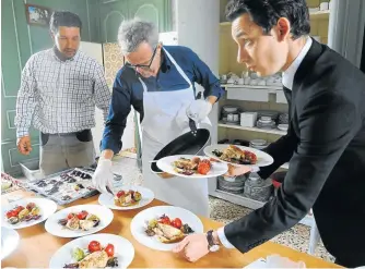  ?? Picture: AFP ?? FROM FIELD TO FORK: Head gardener Sylvain Picard, left, watches French chef Alain Passard in his kitchen in Fille-sur-Sarthe, western France. Passard, the head of the three Michelinst­arred restaurant L’Arpege in Paris, gets his inspiratio­n and passion...