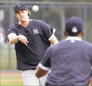  ?? Frank Franklin II / Associated Press ?? The New York Yankees’ Gerrit Cole throws to first base during a drill at a spring training workout in February in Tampa, Fla.