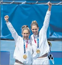  ?? DANIEL LEAL-OLIVAS – AFP VIA GETTY IMAGES ?? Gold medallists April Ross, left, and Alix Klineman of the United States celebrate on the podium after taking the gold medal in beach volleyball.