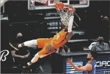  ?? RICK SCUTERI/AP ?? PHOENIX SUNS GUARD JEVON CARTER (4) dunks over Oklahoma City Thunder guard Ty Jerome during the first half of an game Friday in Phoenix.