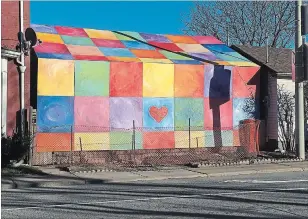  ??  ?? The Rainbow House, as it was called. Colourful plywood painted by Laura Hollick covered up the dilapidate­d building.