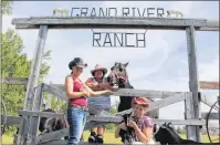  ?? MILLICENT MCKAY/JOURNAL PIONEER ?? Heather Blouin, left, owner of Grand River Ranch, Karen Chapman and Kayla MacLeod near the horses’ paddock with some of the other ranch residents.