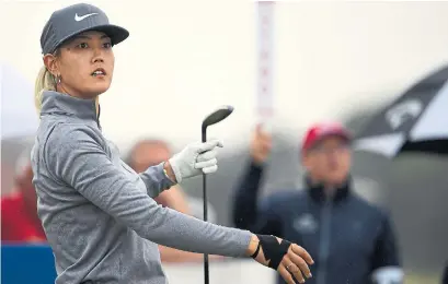  ?? PAUL ELLIS/AFP/GETTY IMAGES ?? A right-hand injury forced Michelle Wie to withdraw midway through the first round of the Women's British Open on Thursday.