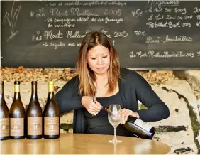  ??  ?? Sarah Hwang pours one of Domaine Huet’s top sweet wines in the winery’s tasting room.