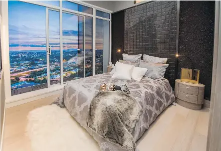  ?? PHOTOS: ARLEN REDEKOP/PNG ?? This display suite bedroom is rich with sensuous texture, thanks to the patterned wallpaper, printed duvet and soft sheepskin rug.