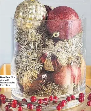  ??  ?? Fill a Baubles vase with festive baubles for colour