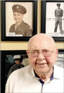  ?? Lynn Atkins/The Weekly Vista ?? Charles Hurl stands in front of the Wall of Honor in Concordia. His picture from World War II is above his right shoulder.