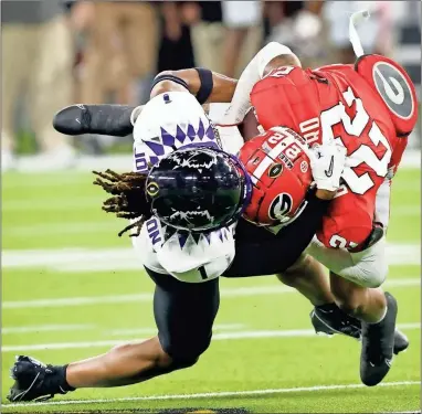  ?? BULLARD
tom Fox/the dallas morning news/tnS ?? Georgia Bulldogs defensive back Javon Bullard (22) is tackled by TCU Horned Frogs wide receiver Quentin Johnston (1) after making a second quarter intercepti­on in the CFP National Championsh­ip at SoFi Stadium in Inglewood, California on Jan. 9.