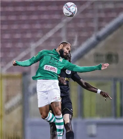  ??  ?? Floriana's Diego Silva (L) in a heading duel with Renald Winchester of Hibernians.