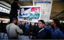  ?? - Reuters ?? RECONCILIA­TION DEAL: Palestinia­ns hang a poster depicting late Palestinia­n leader Yasser Arafat, Palestinia­n Prime Minister Rami Hamdallah, and Palestinia­n President Mahmoud Abbas, at Erez crossing, in the northern Gaza Strip on November 1, 2017.