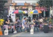  ?? JOHN MINCHILLO—ASSOCIATED PRESS ?? In this June 26, 2020, file photo, diners eat al fresco due to COVID-19 concerns in Manhattan’s West Village.