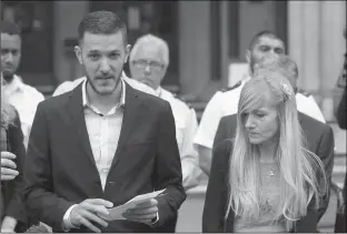  ?? Associated Press ?? n Chris Gard, the father of critically ill baby Charlie Gard, finishes reading a statement Monday next to mother Connie Yates, right, at the end of their case at the High Court in London. The parents dropped their legal bid Monday to send him to the...