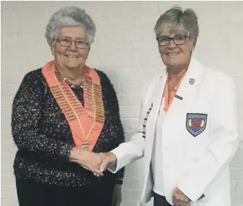  ??  ?? Yaxley’s Viv Hempsell receives the Northants Women’s Bowling Federation presidenti­al chain of office from the outgoing president, Ketton’s Chris Ford, at the annual meeting last week