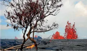  ?? AP ?? Lava erupts from fissures in the Leilani Estates subdivisio­n near Pahoa, Hawaii. Workers were closing off production wells at a geothermal plant which is threatened by a lava flow from Kilauea volcano.