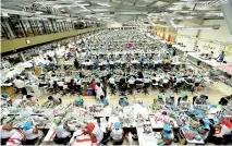  ??  ?? File picture of workers at a garment factory. Unions are demanding a bigger say in how the EPF is managed.