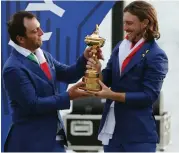  ?? — AP ?? Europe’s Francesco Molinari ( left) and Tommy Fleetwood hold the trophy after Europe won the Ryder Cup in SaintQuent­in- en- Yvelines, Paris, on Sunday.