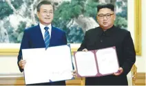  ?? REUTERSPIX ?? Moon and Kim pose for photograph­s with their joint statement in Pyongyang yesterday.