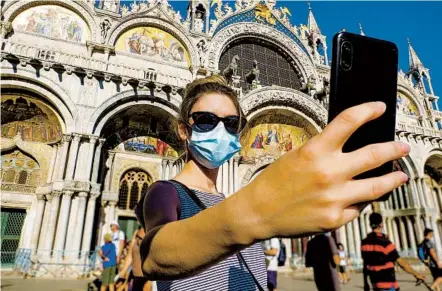  ?? GETTY IMAGES PHOTOS ?? Maintainin­g a safety net for tourists is crucial for tour agencies, especially at once-packed sites such as Piazza San Marco in Venice, Italy.
