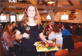  ??  ?? Julia Robeer serves up Dutch comfort food with a Sour Pale Ale from local brewery Poly Amorie at De Vergulden Eenhoorn restaurant, which is in a retrofitte­d circa 1702 former dairy barn. The top-deck patio overlooks Prinsengra­cht canal and the iconic...