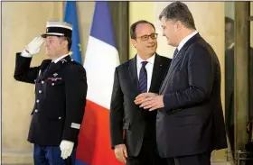  ?? AP/MIKHAIL PALINCHAK ?? French President Francois Hollande (left) chats with Ukrainian President Petro Poroshenko after a meeting Friday in Paris on a peace plan for Ukraine.