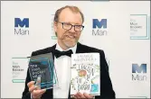  ?? REUTERS ?? George Saunders poses for photograph­ers after winning the Man Booker Prize for Fiction in London on Tuesday.