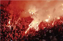  ?? ?? LIGHTING UP CITY: Legia Warsaw fans let off flares in the second half