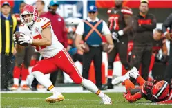  ?? AP Photo/Ron Schwane ?? ■ Kansas City Chiefs tight end Travis Kelce (87) breaks a tackle by Cleveland Browns defensive back Tavierre Thomas (27) on Sunday in Cleveland.