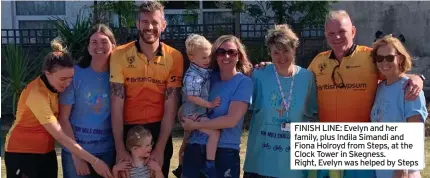  ?? ?? FINISH LINE: Evelyn and her family, plus Indila Simandi and Fiona Holroyd from Steps, at the Clock Tower in Skegness. Right, Evelyn was helped by Steps