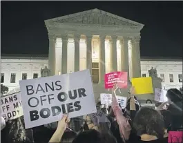  ?? Anna Johnson Associated Press ?? ABORTION RIGHTS supporters gather outside the Supreme Court on Monday night after Justice Samuel A. Alito Jr.’s draft opinion was made public.