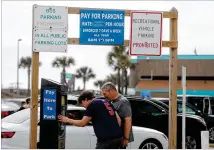  ?? SAVANNAH MORNING NEWS ?? Visitors pay for parking in the lot near Tybee Pier and Pavilion last month. The hourly parking rate increased from $3.50 to $4 as of last month.