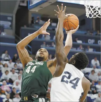  ?? AP photo ?? Michigan State’s Nick Ward shoots over Penn State’s Mike Watkins during the first half in State College, Pa., on Sunday.