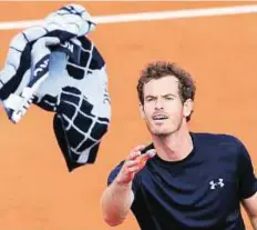  ?? AP ?? Memento Britain’s Andy Murray throws his towel to spectators after winning his French Open first round match.