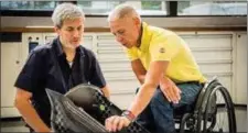  ?? Para athletes Andrea Eskau and Taiki Morii work with Toyota engineers as they review equipment under developmen­t. ??