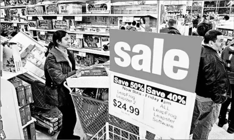  ?? PAUL J. RICHARDS/GETTY-AFP ?? Black Friday shoppers wait to check out with their hard-earned bargains last year in Fairfax, Va. Retailers are hoping for better, bigger results this year.