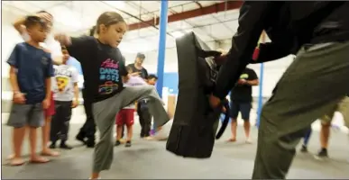  ?? PHOTO VINCENT OSUNA ?? Zoei Mercado, 6, of Calipatria, practices her low kicks during a self-defense class for children with special needs on Saturday at Ricochet Rec Center in Imperial.