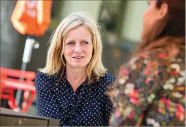  ?? Herald photo by Ian Martens ?? Alberta NDP leader Rachel Notley speaks with downtown business owner Levi Cox at the outdoor tables at Festival Square Wednesday during her visit to the city. @IMartensHe­rald